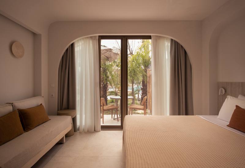 Nusa — suite interior opening onto a garden terrace